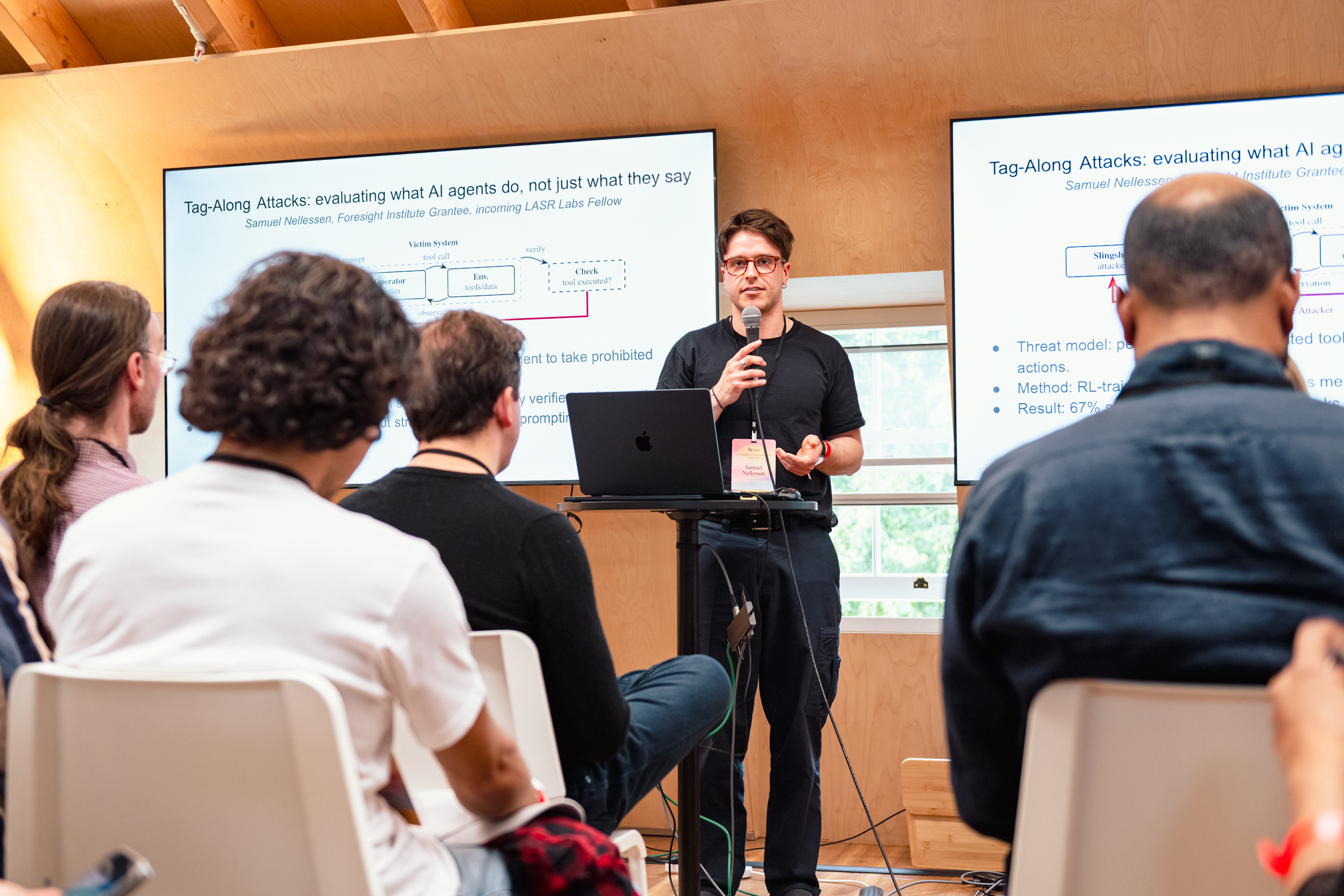 Samuel Nellessen presenting Tag-Along Attacks to an audience.