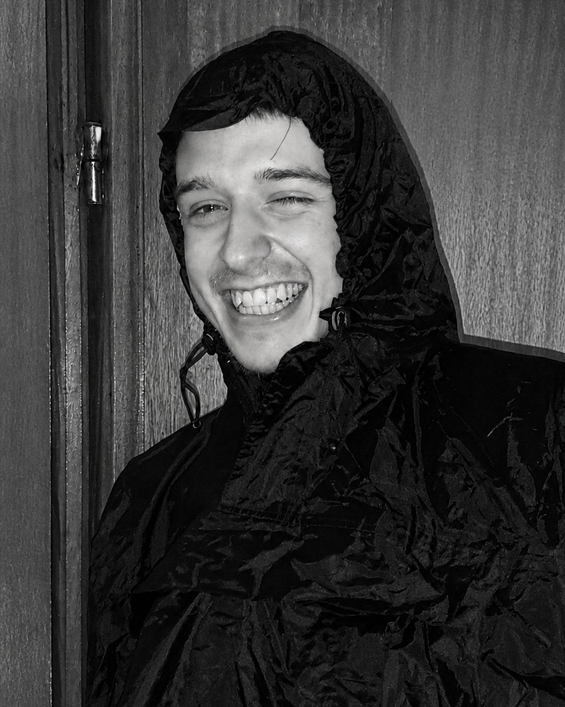 Samuel Nellessen smiling in a black hooded jacket.